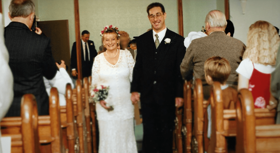 a bride and groom are walking down the aisle of a church