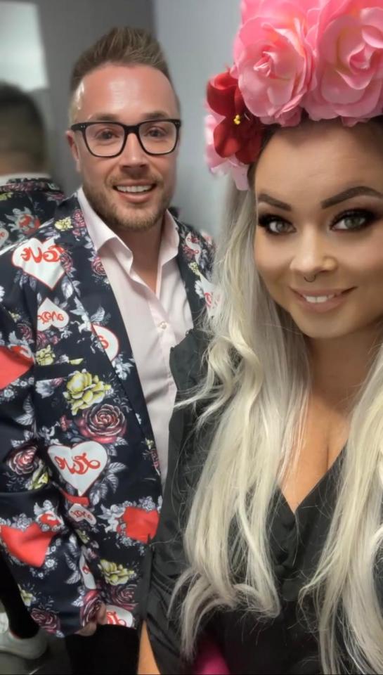 a man and a woman are posing for a picture and the woman is wearing a flower crown