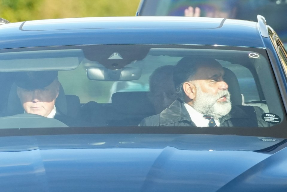 two men are sitting in a blue audi car