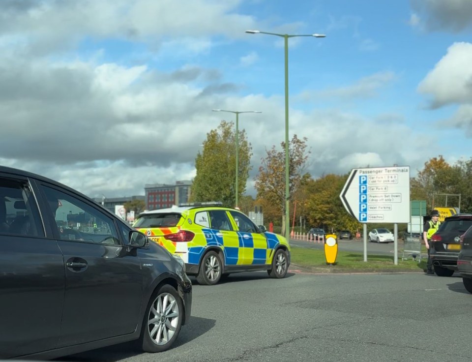 a blue and yellow police car is driving down a street