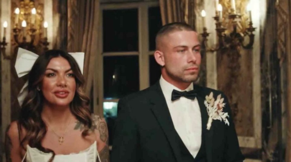 a bride and groom are standing next to each other in a room .