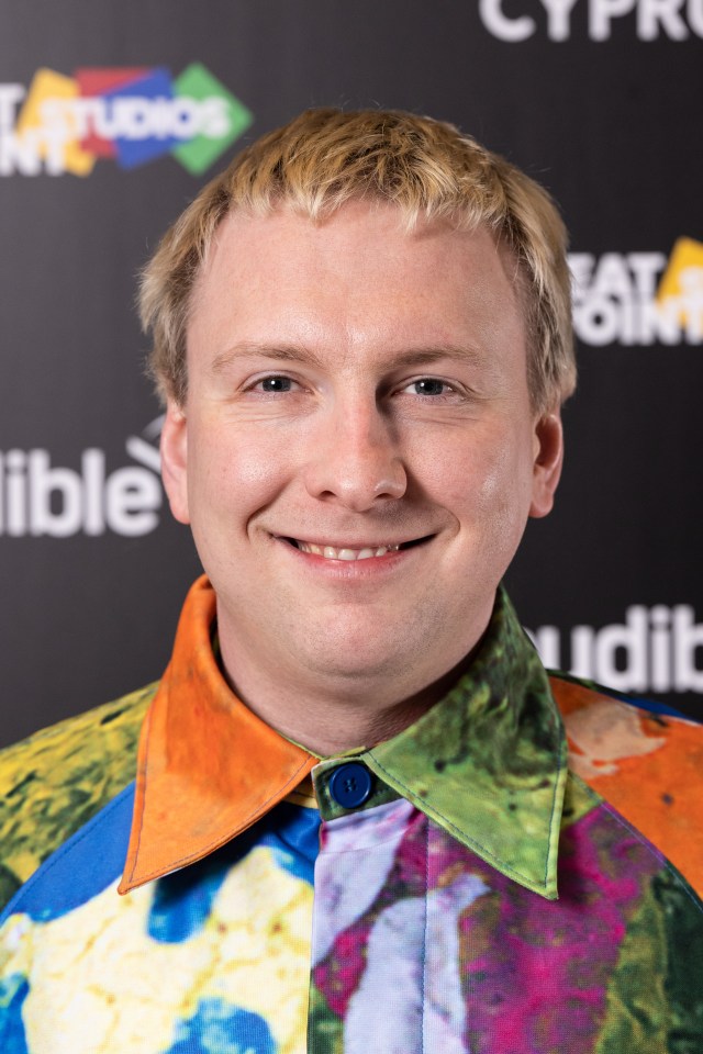 a man is smiling in front of a sign that says studios