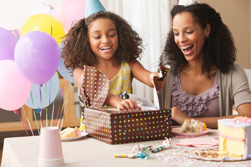 a woman and a little girl are celebrating a birthday