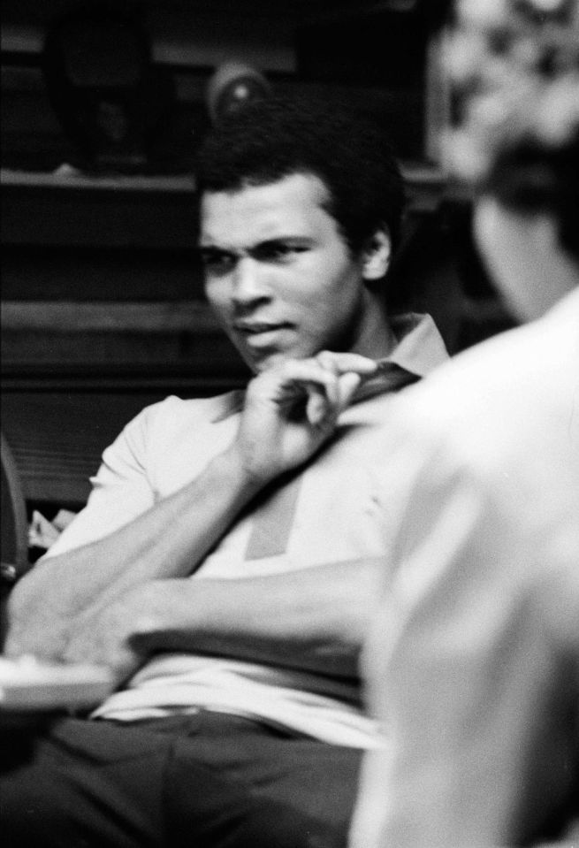 a black and white photo of a man in a white shirt