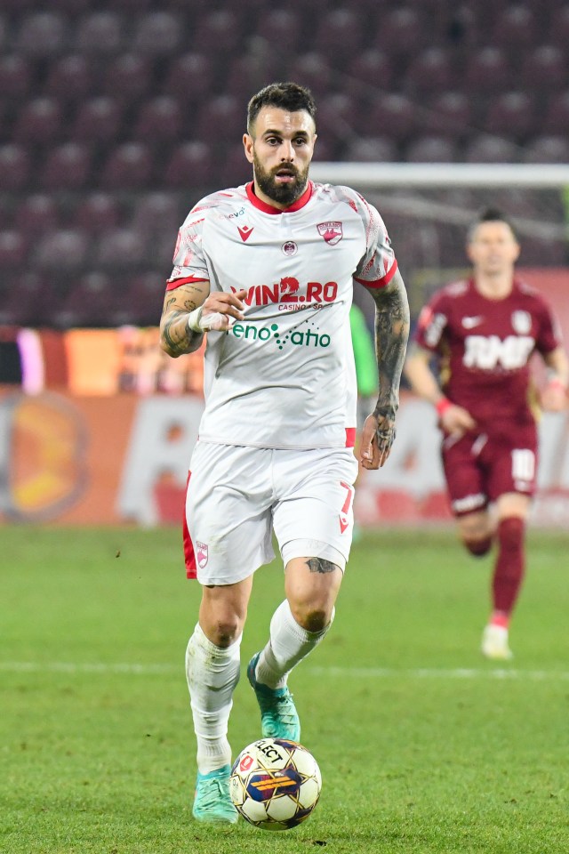 a soccer player wearing a white jersey with the word win on it