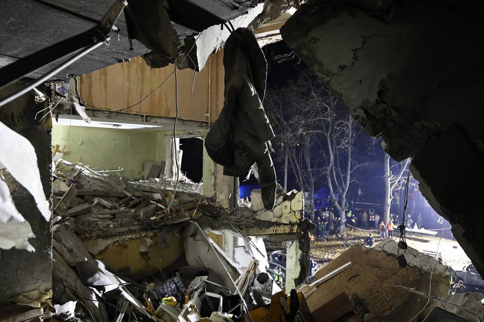 One chilling image appears to show a child's coat hanging from a loose hook on a roof from a caved in apartment