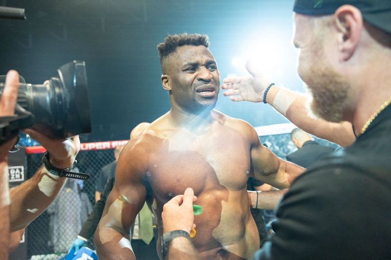 a shirtless boxer is being interviewed by a cameraman in front of a sign that says opera