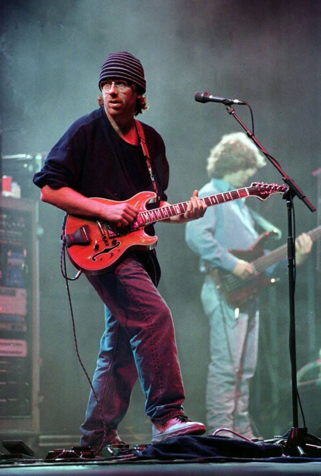 ** FILE ** Phish lead guitarist Trey Anastasio, left, and bassist Mike Gordon performs at a concert in Limestone, Maine, in this August 1997 file photo. Fans of Phish are waiting to hear if the jam band will play at the Coventry, VT. event this summer. Organizers say they shouldn't have to wait too much longer.(AP Photo/Robert F. Bukaty, File)