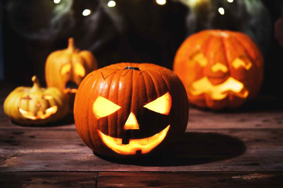 a group of carved pumpkins are sitting on a wooden table