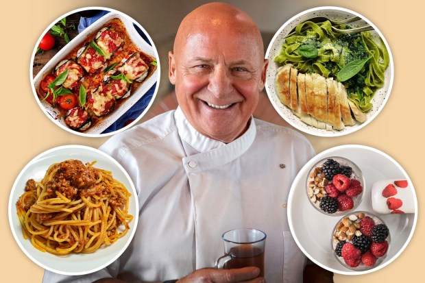 a man is surrounded by plates of food including spaghetti chicken and fruit