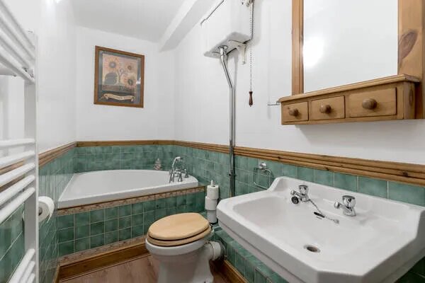 The bathroom has Victorian features like an old-style toilet