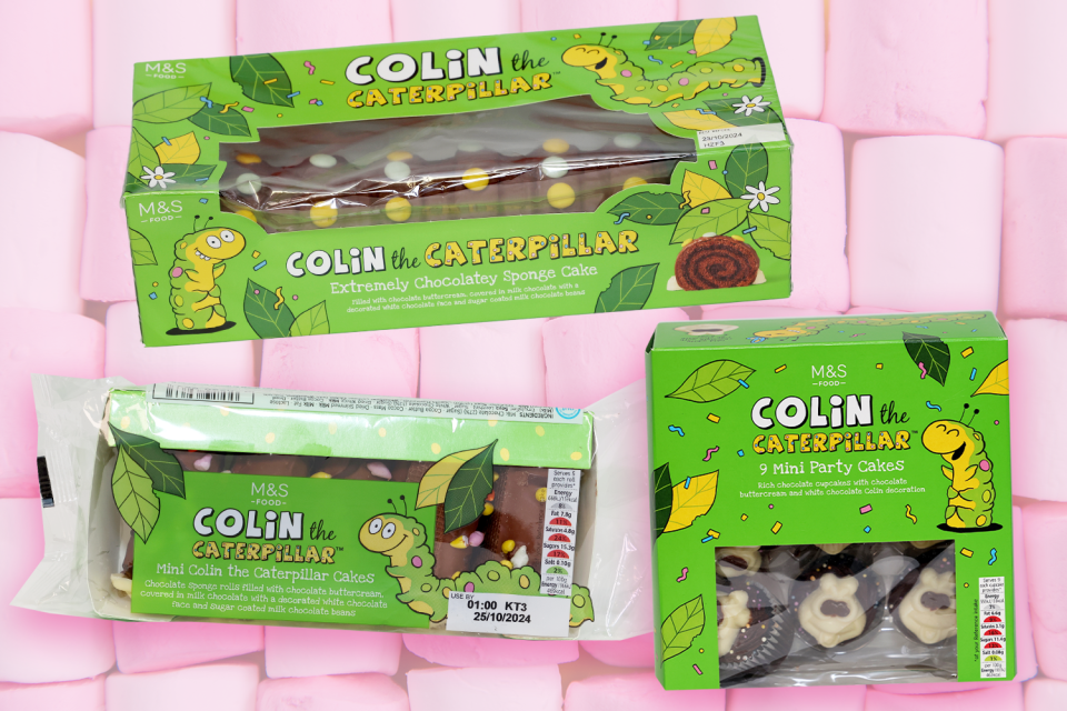 two boxes of colin the caterpillar cakes sit on a pink marshmallow background