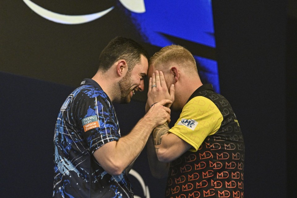 Mandatory Credit: Photo by Godfrey Pitt/Action Plus/REX/Shutterstock (14778069ak) Luke Humphries congratulates Mike De Decker on his victory; 13th October 2024, Mattioli Arena, Leicester, England; 2024 PDC BoyleSports World Grand Prix Darts Final. World Grand Prix Darts, Mattioli Arena, Leicester, UK - 13 Oct 2024