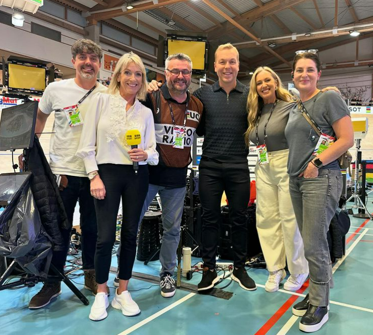 a group of people posing for a picture with one wearing a shirt that says video radio