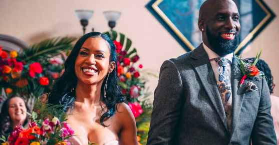 a bride and groom are smiling while walking down the aisle