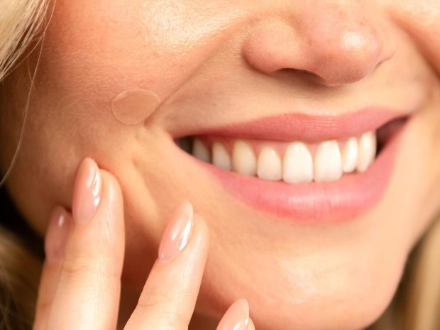 a close up of a woman 's face with a patch on it