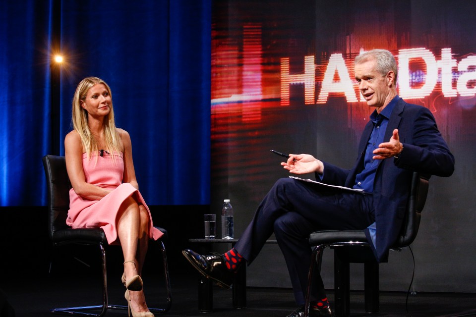 a man and a woman are sitting in front of a screen that says harddie