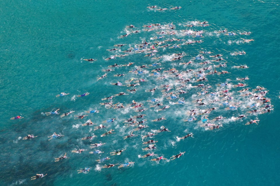 a man wearing goggles is swimming in the ocean