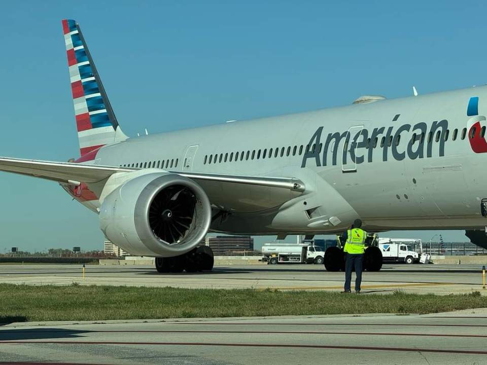 An airport work inspecting the damage