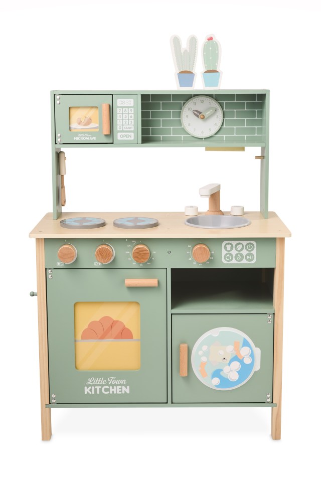 a green little town kitchen with a clock on top