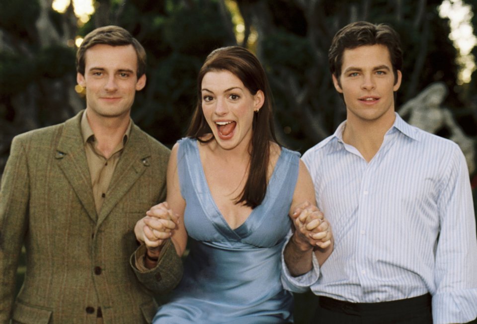 a woman in a blue dress is holding hands with two men