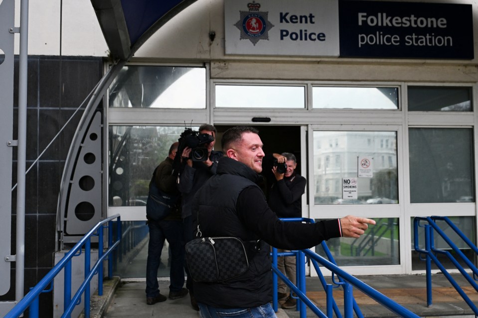 a man is walking out of the folkestone police station