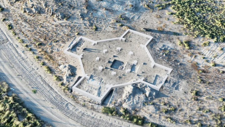 an aerial view of a building in the middle of a desert