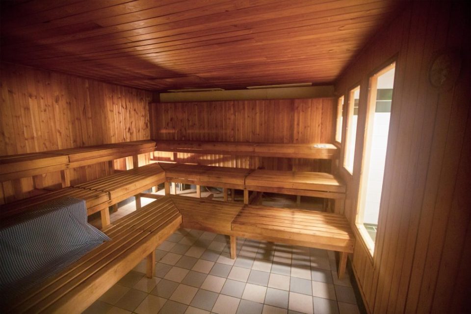 a wooden sauna with a clock on the wall