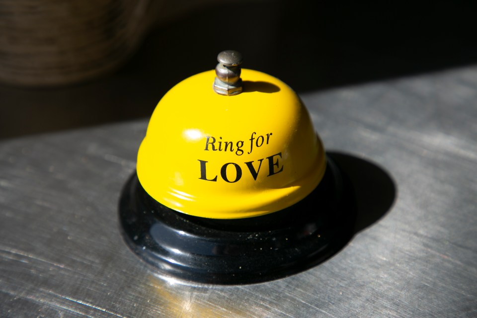 a yellow bell that says ring for love on it