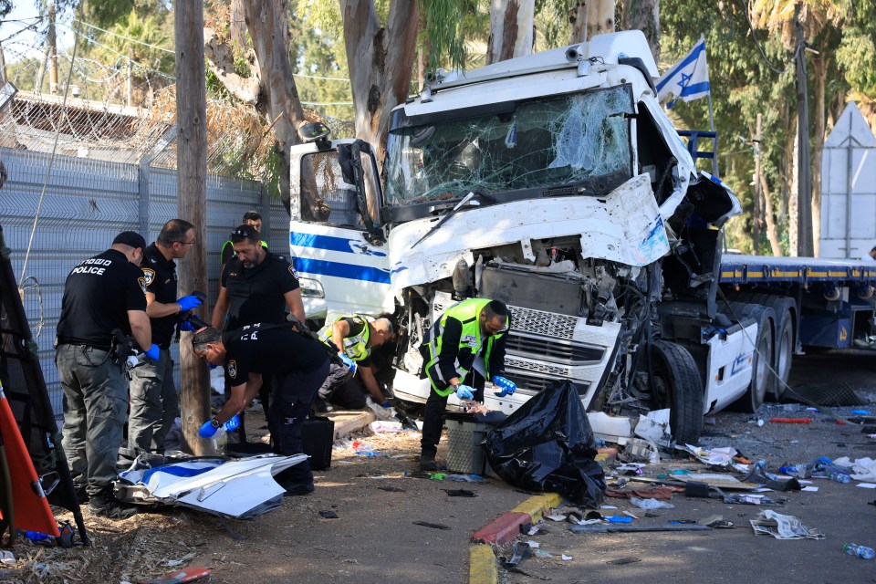 Authorities inspect debris from the truck wreckage