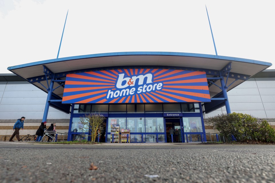 the entrance to a b&m home store with people walking in