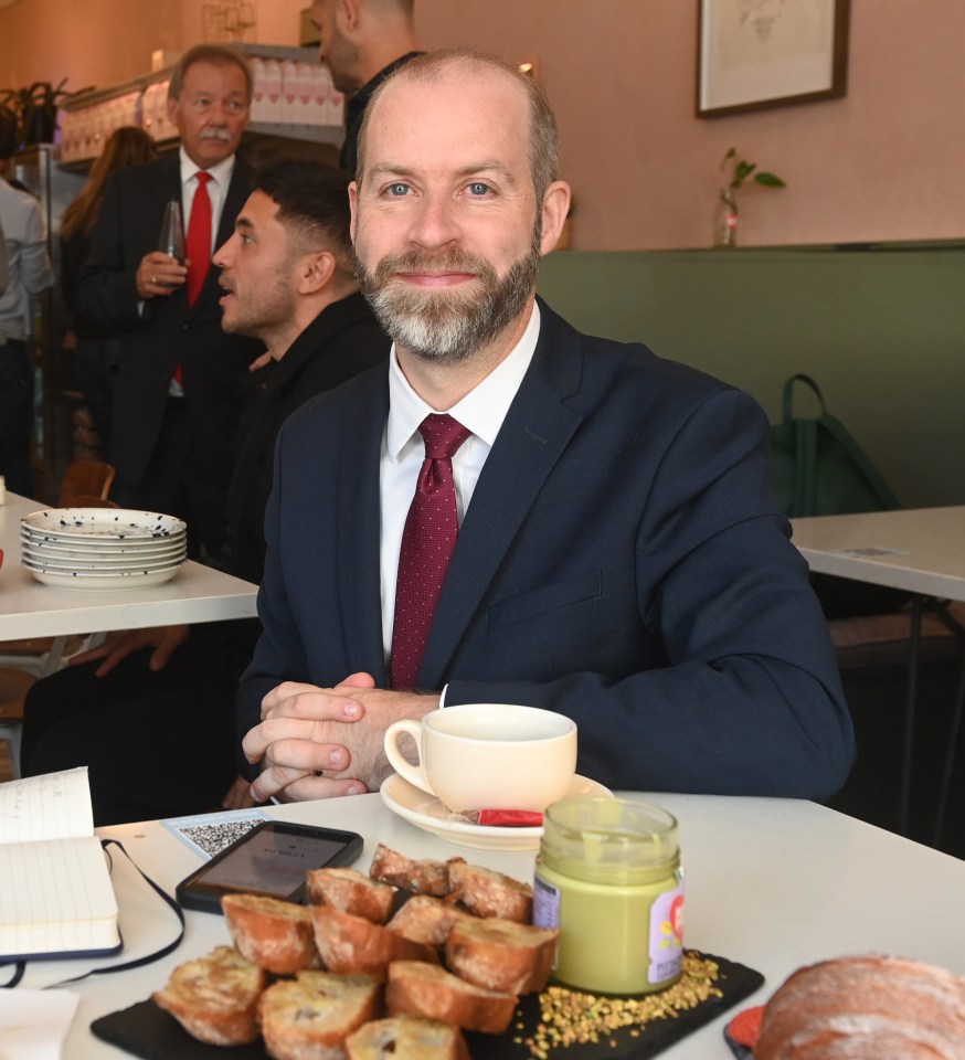 a man and a woman sit at a table in a restaurant