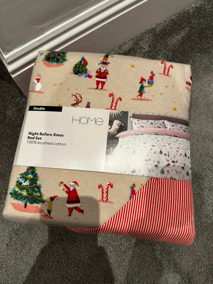 a christmas bedding set with santa claus and elves on it