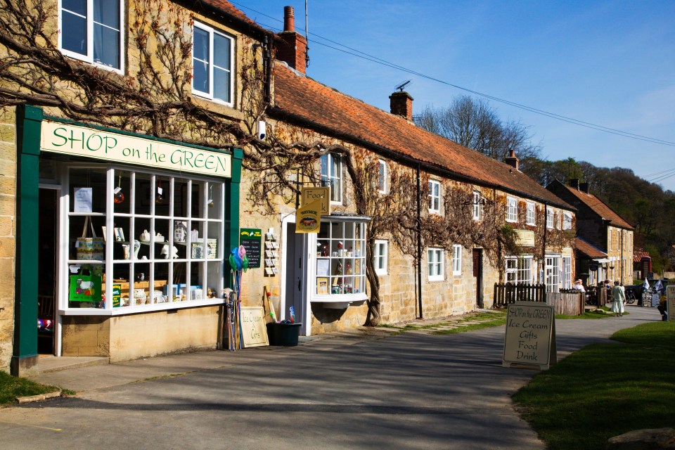 a bicycle is parked in front of the village store