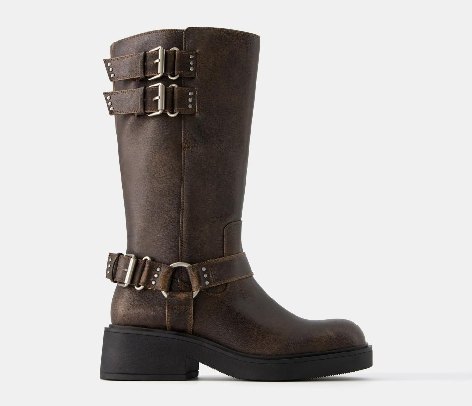 a pair of brown leather boots with silver buckles on the side