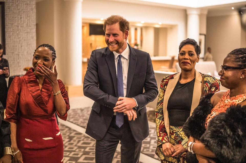 Harry is all smiles as he looks after Sentebale business on Thursday - without Meghan