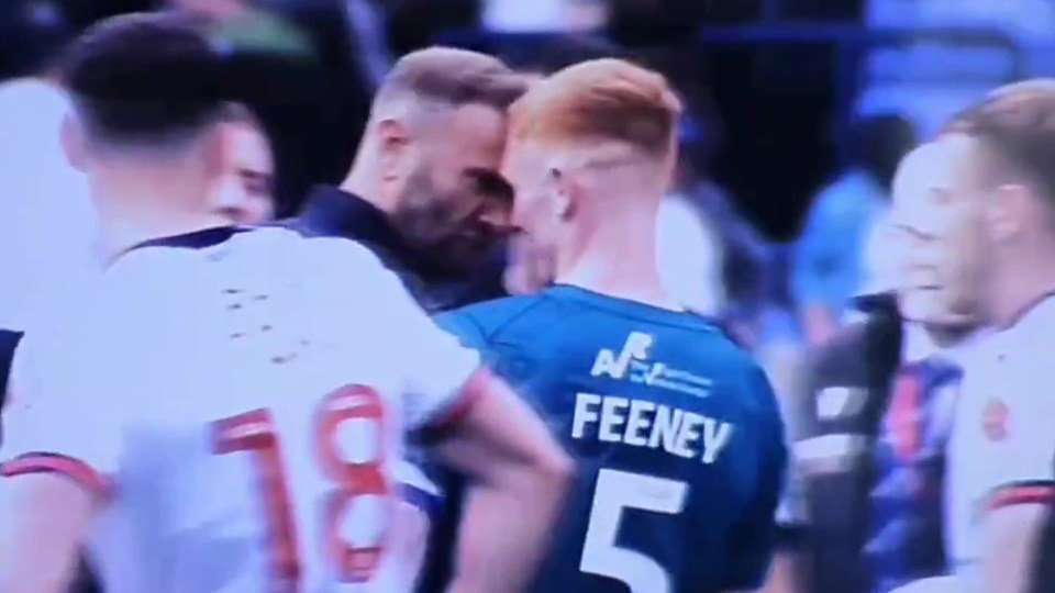 a soccer player with the number 5 on his back is talking to another player .