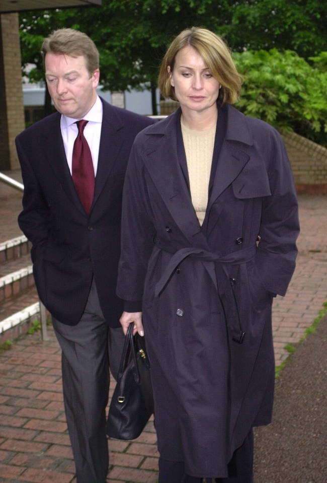 a man and a woman are walking down a brick sidewalk