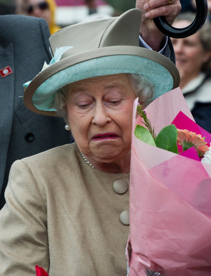 queen elizabeth is holding a bouquet of flowers and making a funny face