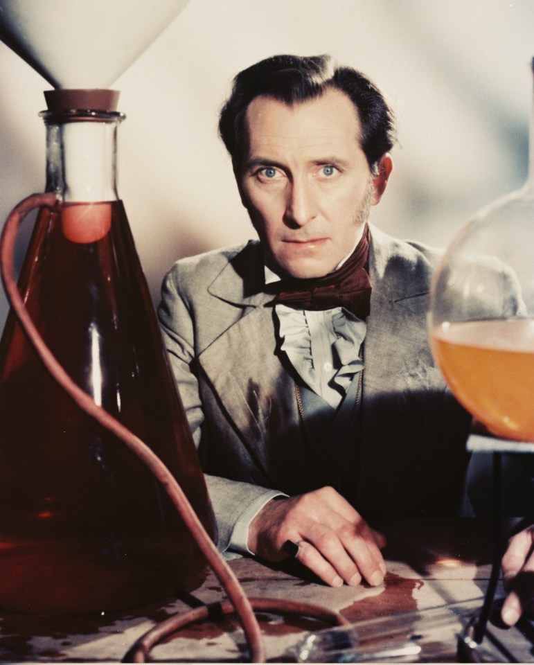 a man sitting at a table with a bottle of liquid in front of him