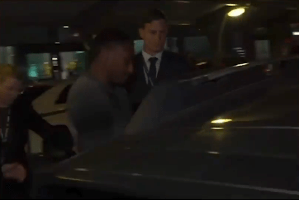 a man in a suit and tie is getting out of a car