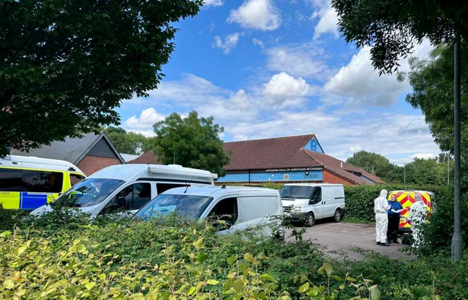 several vans are parked in front of a blue building