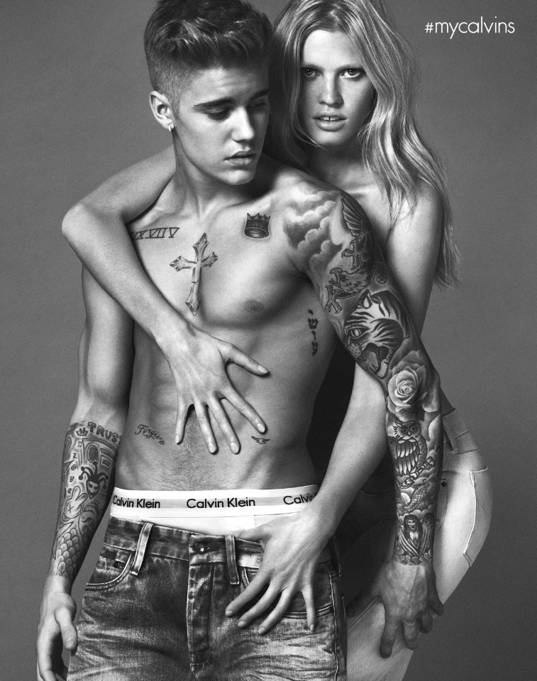 a black and white photo of a man and woman wearing calvin klein underwear