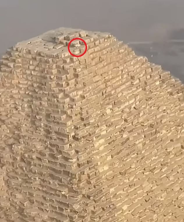 A birds-eye view of the Giza Pyramid with the dog being just a speck on the gigantic structure