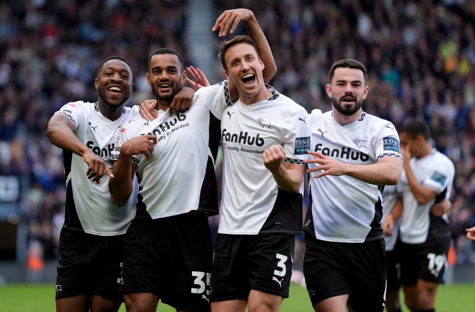 a group of soccer players wearing fanhub jerseys