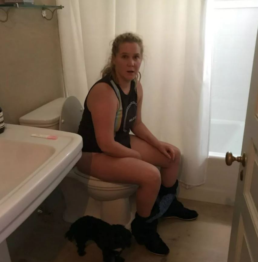 Amy Schumer, pictured, looked shocked as she sat on the toilet doing a pregnancy test