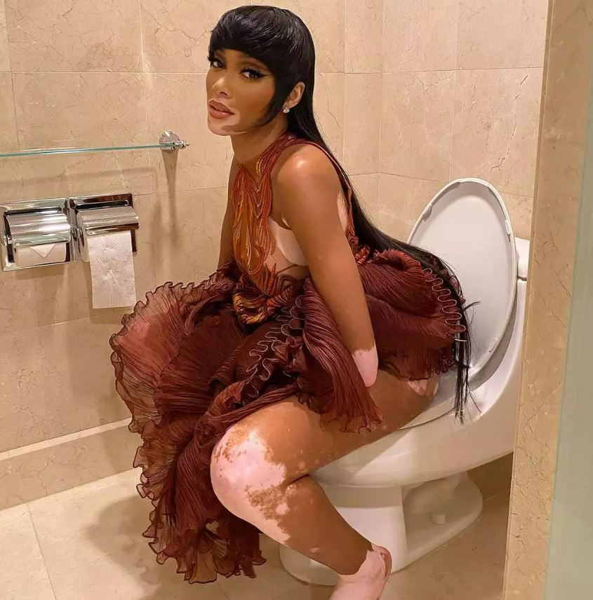 Winnie Harlow, pictured, looked confidently at the camera as she posed on the toilet