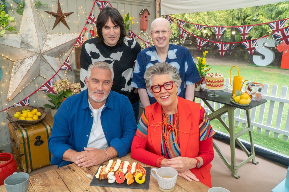 four people sitting at a table with a sign that says s on it