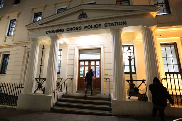 the entrance to the charing cross police station is lit up at night