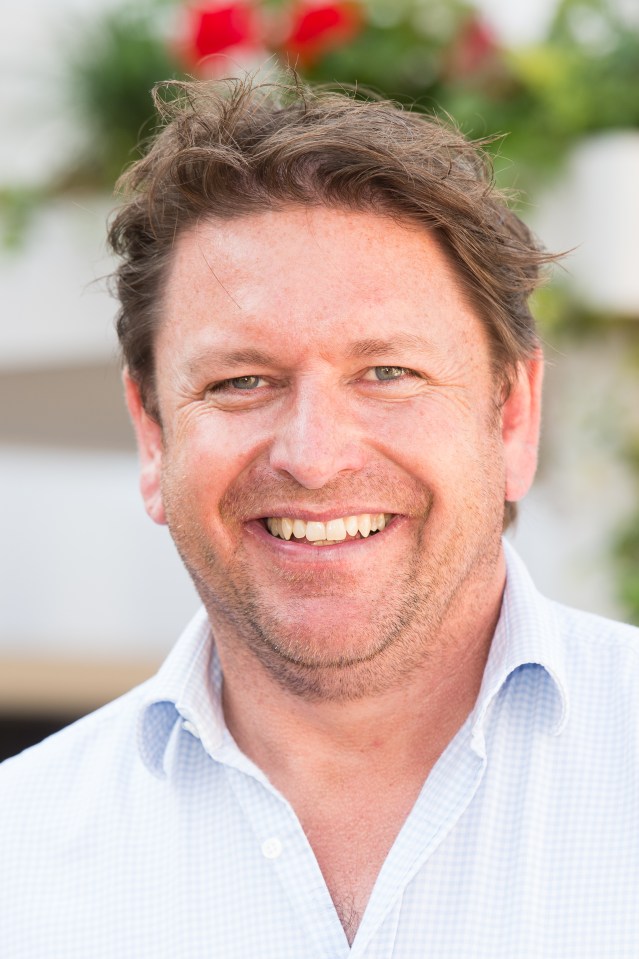 a man in a blue shirt smiles for the camera